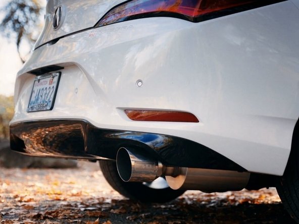 Stand back from the car and verify that the tip is centered and has at least 1/3 inch clearance from the bumper on both sides
