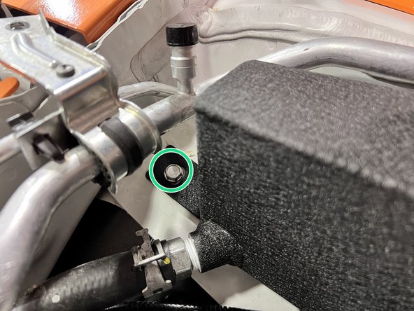 Using a provided M6 washer and a 12mm long M6 flanged bolt, torque to snug down the upper mount bolt for the coolant tank