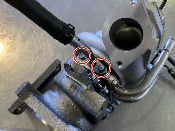 Reinstall the Oil Return Hard Pipe using the (2) OEM 10mm bolts as shown. Torque to 12 lb-ft 