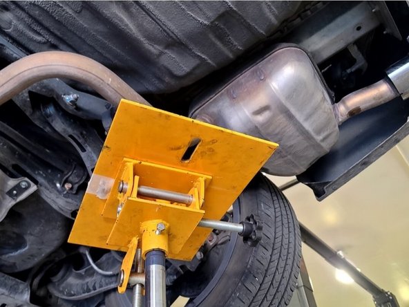 Using the same location as before, support the back of your 27WON exhaust with a friend or jack