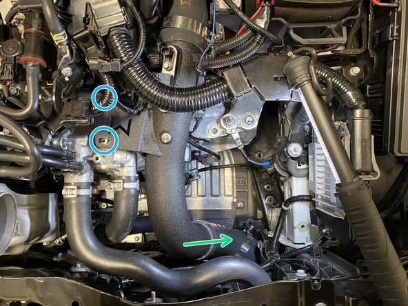 While holding the throttle body silicone, press the cold pipe into the silicone coupler as shown