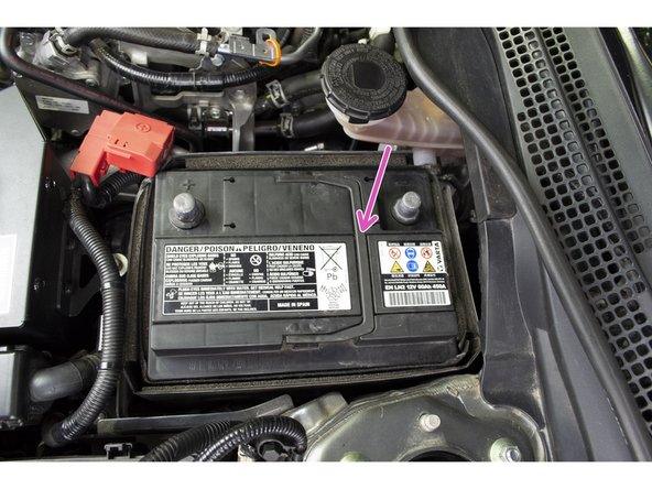 Loosen the nut (red circle) with a 10mm deep socket and ratchet then remove the hook and battery tiedown from the battery