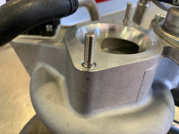 Thread the provided screws for the inlet face on to the turbo as shown