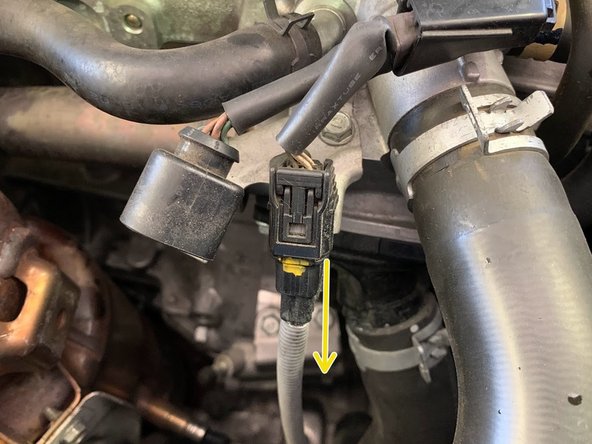 Unplug the lower oxygen sensor electrical pigtail connector located next to the upper oxygen sensor connector