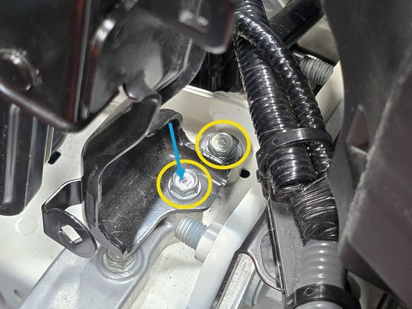 Using a 10mm socket, a long extension, and a 3/8&quot; drive ratchet remove the two 10mm bolts shown circled in yellow