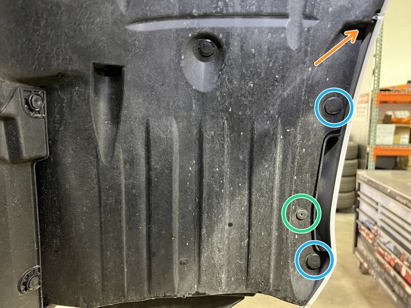 The passenger side wheel and tire were removed for clarity but not required for bumper removal. Passenger side shown, Driver side similar