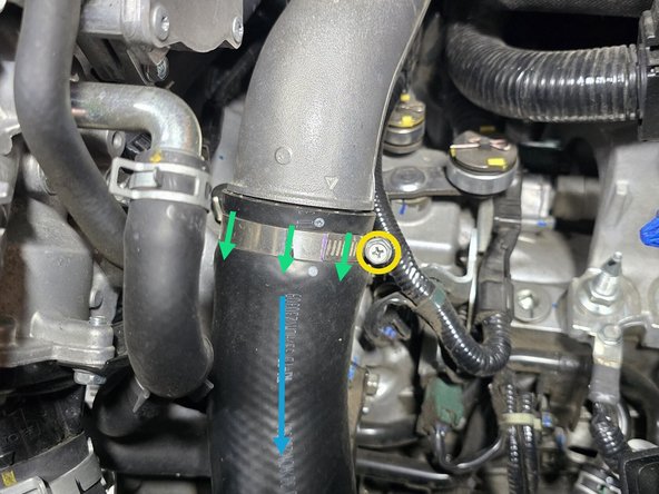 Using a 10mm socket and 3/8" drive ratchet, loosen the clamp where the OEM boost tube connects to the OEM cold pipe