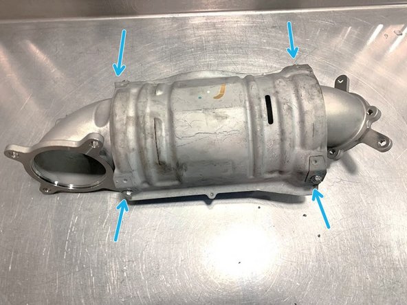 The heat shield is sharp and can catch on the bit. Use a vice to hold the heat shield