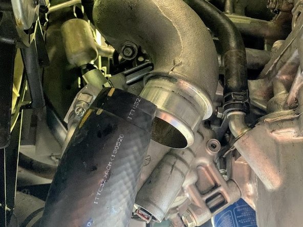 Free the boost tube from compressor cover outlet