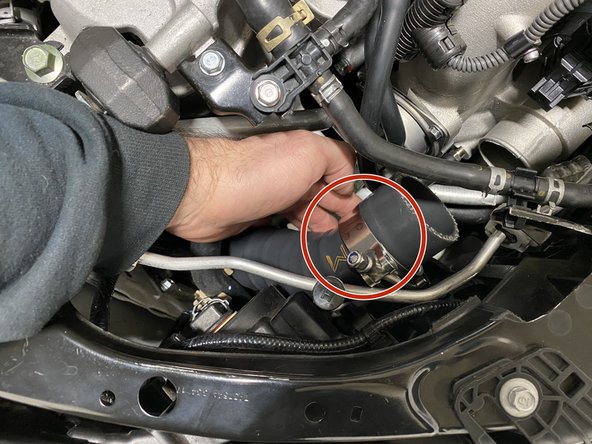 Again, route the assembled silicone and pipe up through the fender opening that the OEM hot pipe was routed through