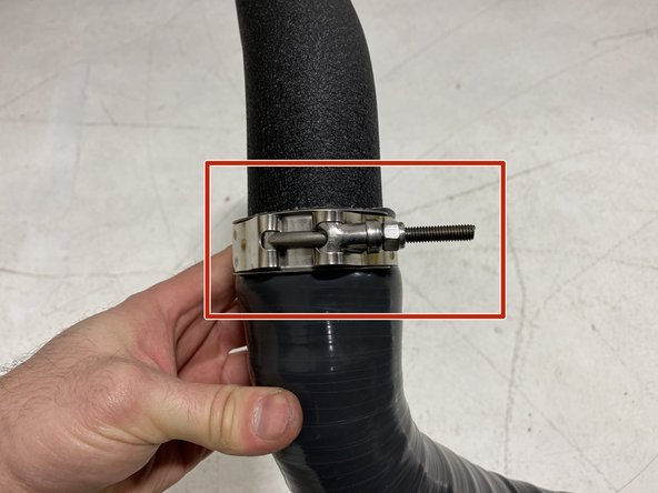 Install a 63-71mm T-Bolt clamp over the pipe to silicone interface as shown
