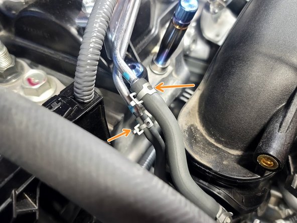 Use pliers to slide the two (2) hose clamps down the rubber hose