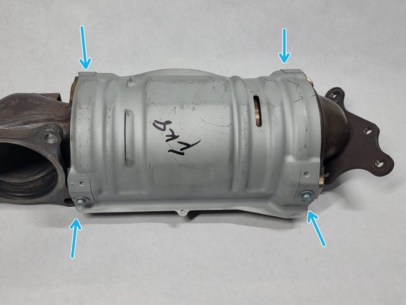 Remove four (4) bolts from the lower heat shield using a 10mm socket or wrench. Set aside bolts. They will not be reused
