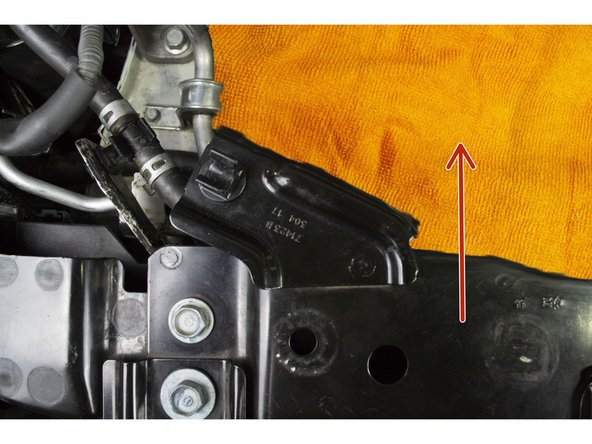 When drilling in the next step be mindful to not hit the coolant line that is clipped below, Unclip the coolant line and make sure it is out of the way