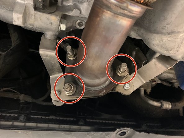 Use a 14mm socket and ratchet to remove the three OE nuts