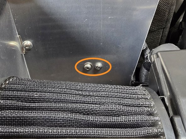 Press the provided M5 cap head bolts through the shroud and upper battery bracket as shown