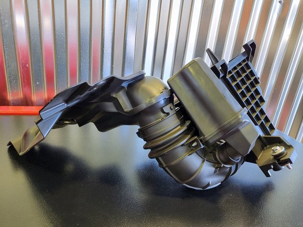 Wiggle the airbox and pull it up at the same time to loosen the airbox from the rubber bushing