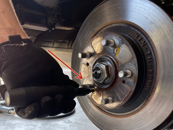 Remove the (2) Philips screws with an impact driver as shown