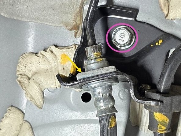 Use a large flat head screwdriver to pry the retention tab out as shown with the arrow