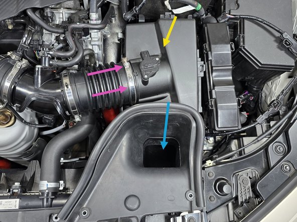 Insert the airbox into the engine bay in a similar manner that it was removed