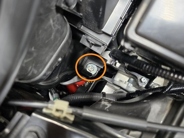 Using a 10mm socket, and a 12" extension hand thread the lower mounting bolt