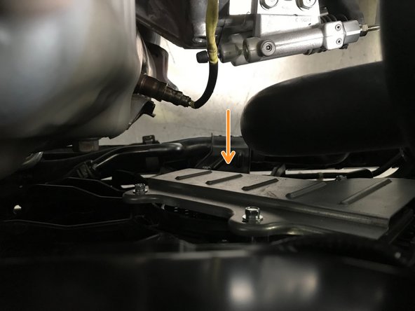 Moving the radiator hose allows improved clearance for downpipe removal