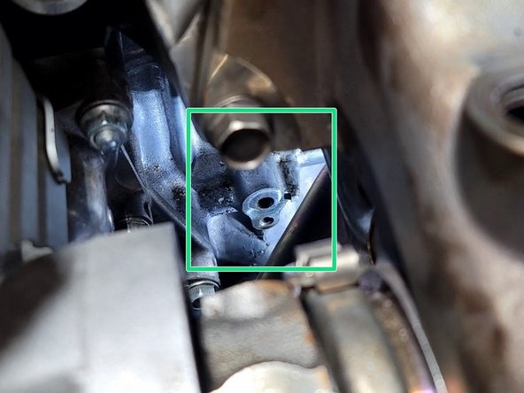 Locate the oil feed block connection location shown in the first image