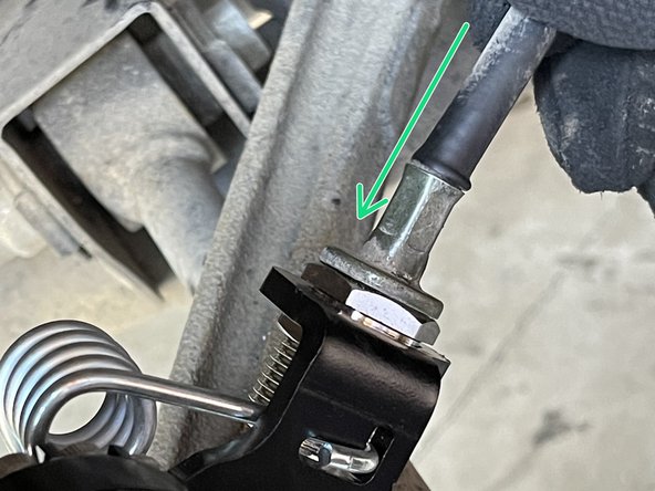 Guide the parking brake cable through the adjustment screw
