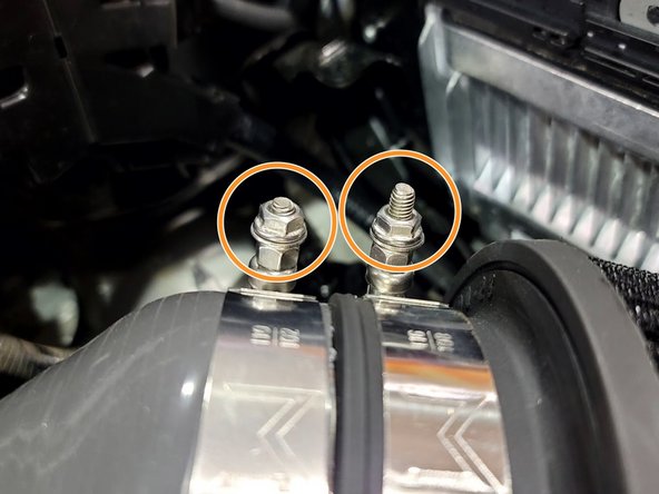 Remove both M6 nuts as shown. There are washers under the nuts. Those remain in place