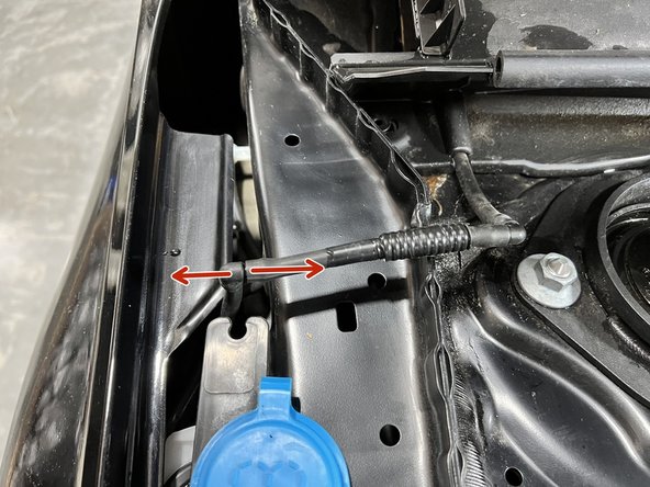 Disconnect the windshield washer hose  by pulling the halves apart