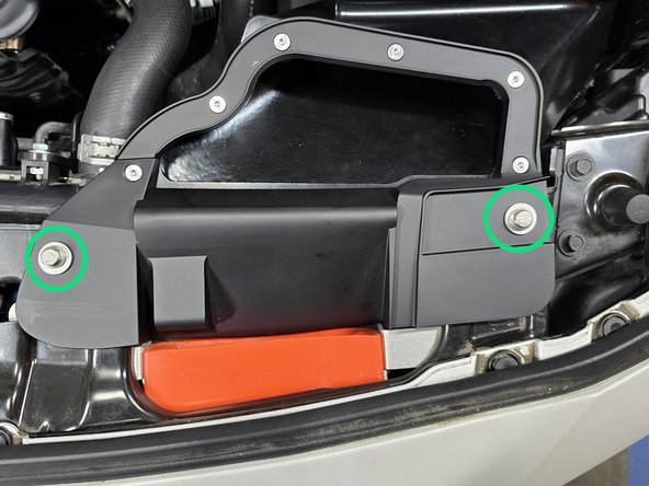 Thread the provided 20mm long M6 bolts and rubber washers into the airbox inlet mounting holes as shown