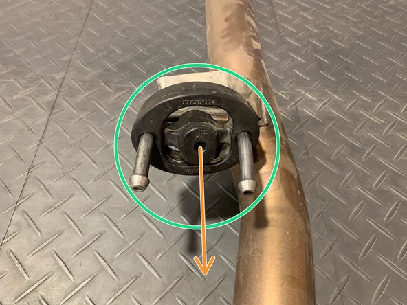 Using a spray cleaner, lubricate the front  hanger and rubber support as shown