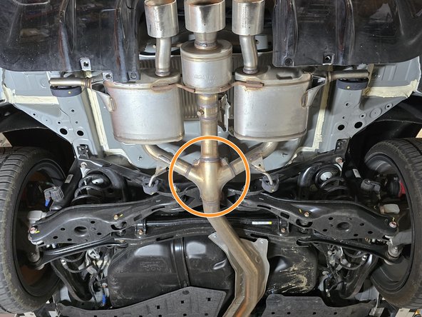 Using a transmission jack, floor jack, or a friend support the OE exhaust in the marked area
