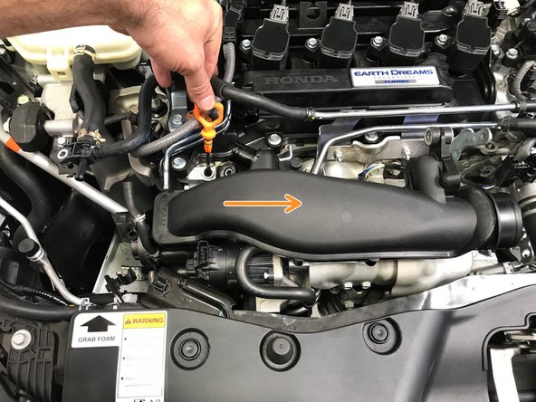 Rotate and lower the TIP into the engine bay then move it towards the driver's side of the engine bay