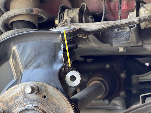 Using tin snips or a cut off wheel, trim the brake dust cover as shown