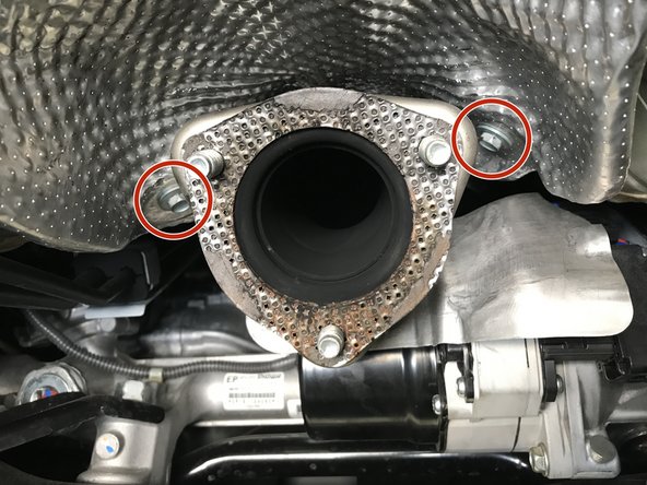 Use a 10mm socket and ratchet to remove the five 10mm bolts holding the heat shield