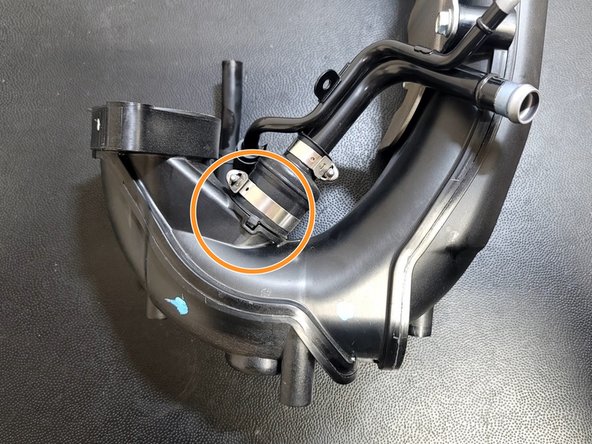 Use caution not to damage the rubber fitting. This is tricky