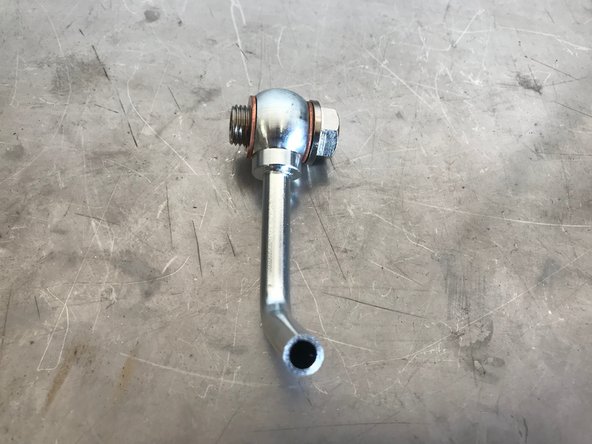 Assemble the lower coolant pipe as shown.  There should be one crush washer on each side of the coolant pipe bolt connection