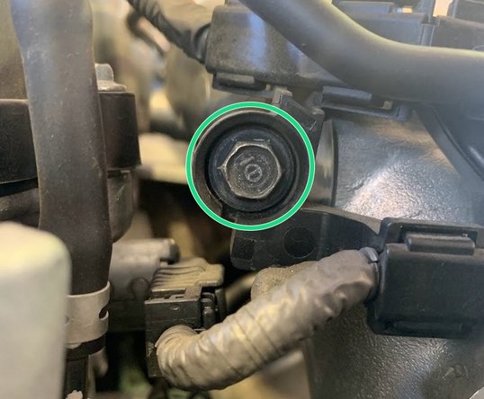 Using ¼ inch ratchet, 10mm deep socket, and 3 inch extension, remove the 10mm bolt shown