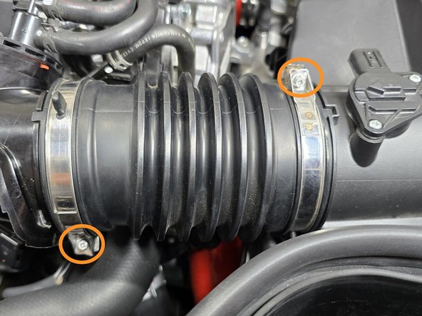 Use a 5.5mm socket and 3/8&quot; ratchet or a small Phillips screwdriver to loosen the one EVAP elbow clamp circled in yellow