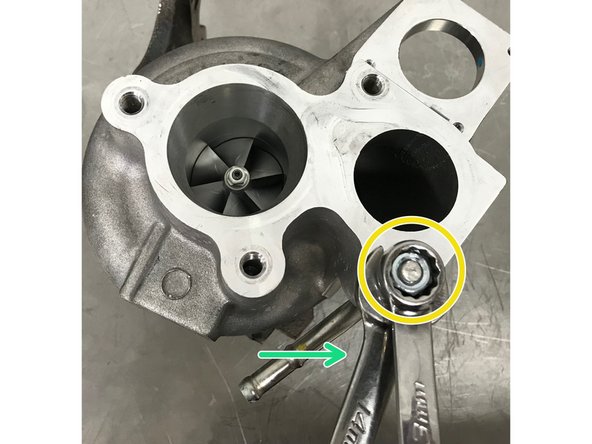 Thread on the OE flange jam nut onto the turbo stud on top of the M8 nut, this is shown off the turbo for clarity