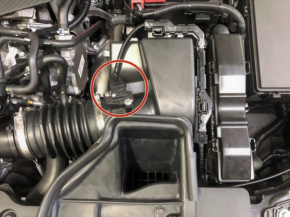 Unplug the MAF sensor by pushing down on the tab (red circle) on top of the wiring connector