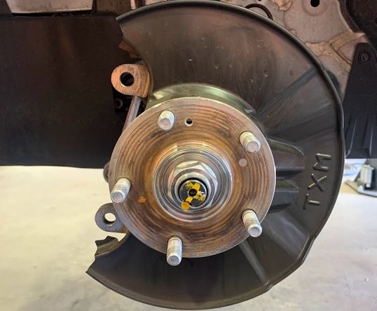 With retention screw removed, slide the rotor outward off the wheel studs