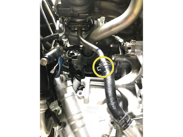 Use pliers to install the spring clamp at the end of the rubber hose around the oil drain pipe