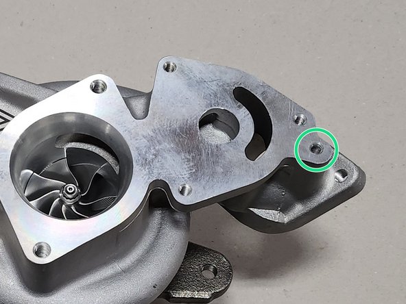 Thread by hand the barb into the area circled in green