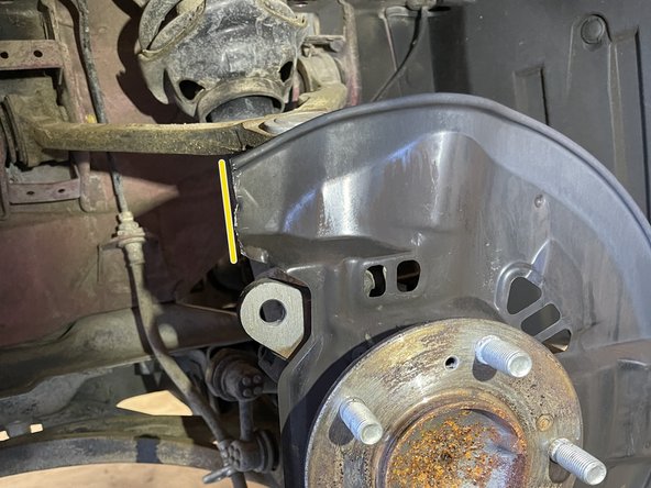 Using Tin snips or cut off wheel, trim the brake dust shield as shown