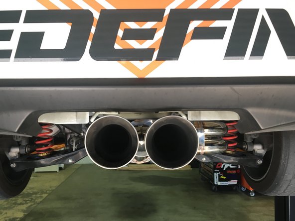 If the tips are not centered try gently shaking the exhaust to settle the rubber hangers