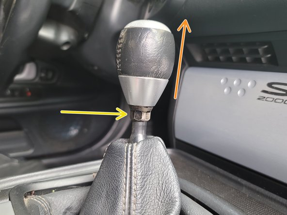 Using a 14mm wrench, loosen the 14mm locking nut on the shift knob