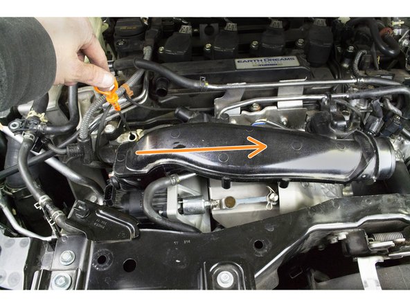 Rotate and lower the TIP into the engine bay then move it towards the driver's side of the engine bay