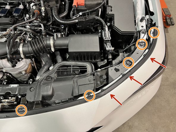 Use a large flathead screwdriver or prying tool to remove the ten (10) push-clips on the top of the bumper